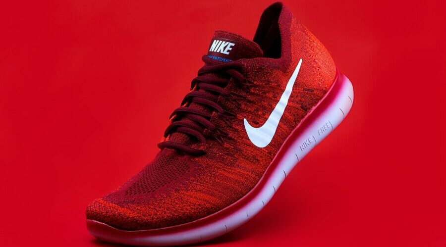 unpaired red Nike sneaker